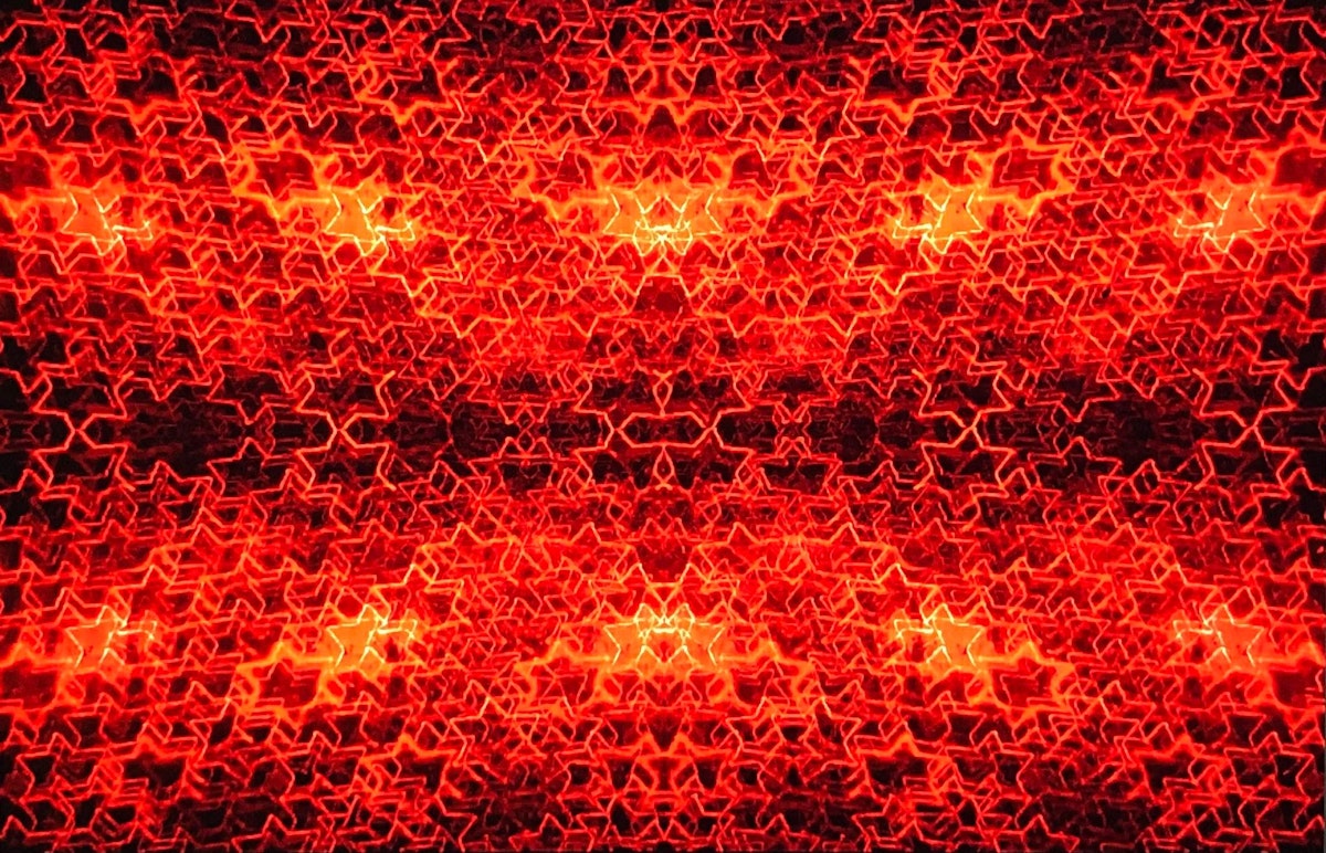A fiery red image made up of hundreds of red glowing stars on a black background. In some parts of the image the stars have so many layers it almost becomes a block colour. The layering of the image creates depth.